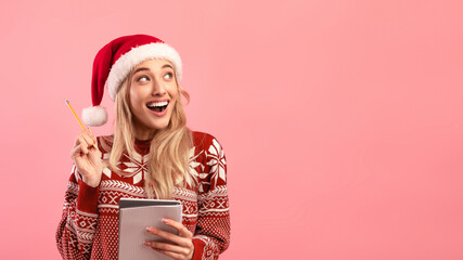 Excited lady in Christmas outfit writing New Year resolutions in copybook on pink background, banner design, copy space