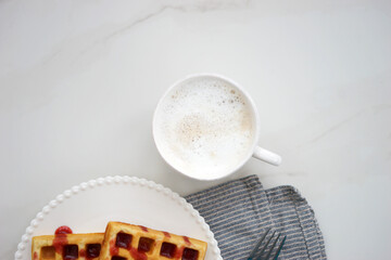 Wall Mural - Breakfast with Belgian waffles and coffee and milk foam