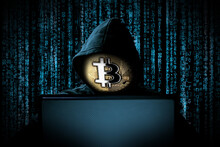 Hacker With Bitcoin Face Mask Behind Notebook Laptop Front Of Blue Source Binary Code Background Internet Cyber Hack Attack Crypto Currency Blockchain Computer Concept