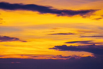 Wall Mural - dark clouds on the glowing sky at sunset. dramatic nature scenery on the windy weather in evening