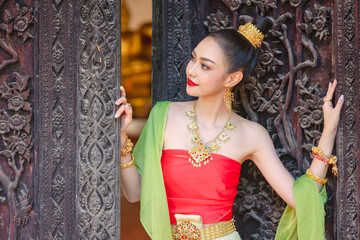Wall Mural - Luxury portrait of a beautiful Thai girl in traditional thai red costume, identity culture of Thailand, identity culture of Asia