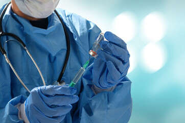 A medical staff getting a coronavirus vaccine in syringe from the medicine bottle. Covid-19 Vaccination