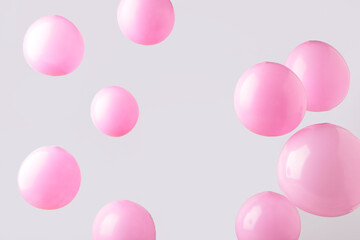 Pink pastel baloons on grey background. Minimalism