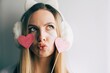 Close up portrait of a young fashion beautiful blonde woman. Girl hipster with pink hearts. Valentines day. Love.Space for text.