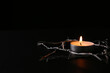 Burning candle and star of David made with barbed wire on black background, space for text. Holocaust memory day