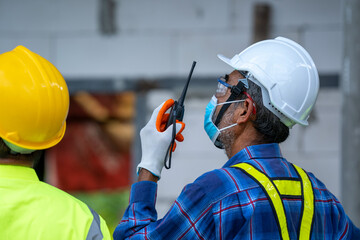 Aufkleber - Engineer wearing protective mask to Protect Against Covid-19 and checking production process at the construction site,Engineer,Construction concept,Coronavirus has turned into a global emergency.