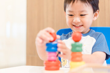 4 years old kid boy online learning class study math or counting number and color.asian boy play colorful wooden toy at home.New normal.education, smart kid boy motor skill.Social distancing.stay home