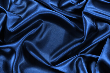 Wall Mural - Blue silk satin background. Shiny fabric with wavy folds. Beautiful fabric background with empty space for your design.
