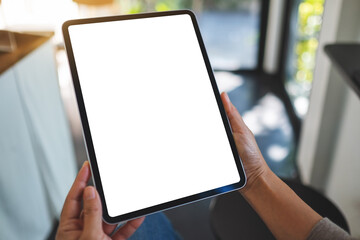 Mockup image of a woman holding digital tablet with blank white desktop screen