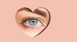 Beautiful girl gray eye in a hole in the shape of a heart. Shining skin color foreground