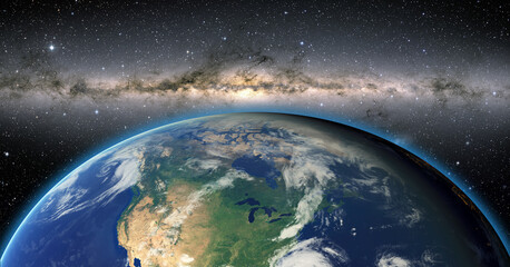 view of the planet earth from space during a sunrise against milkyway galaxy 