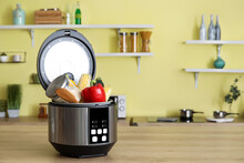 Modern Multi Cooker With Vegetables On Table In Kitchen