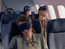 Passengers Sleeping On Airplane With Eye Masks
