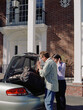 © SuperStock - Couple loading trunk of car