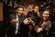 © SuperStock - Friends drinking in kitchen at New Year's Eve party