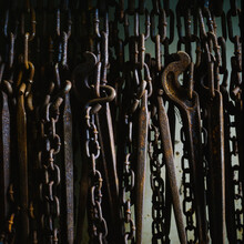 Close Up Of Rusty Chains Hanging Against Side Of Ship