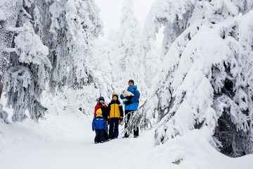 Sticker - Happy family with three children and puppy dog, hiking in mountains wintertime, lots of snow