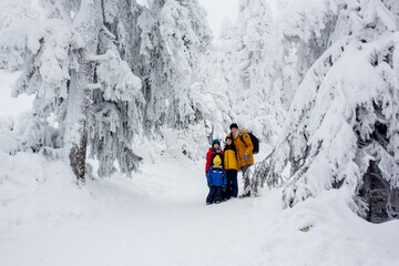 Sticker - Happy family with three children and puppy dog, hiking in mountains wintertime, lots of snow