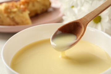 bowl and spoon with condensed milk, close up