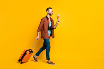 Sticker - Full length body size side profile photo of smiling man baggage keeping documents camera in airport isolated bright yellow color background