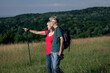© Zoran Zeremski - Active senior couple with backpacks hiking in nature .