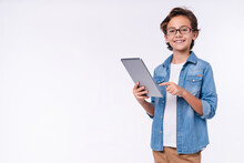 Smart Young White Boy Using Tablet In Casual Outfit Isolated Over White Background
