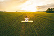 © Julia - Curvy girl doing yoga in nature.