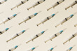 © fStop - COVID-19 vaccine syringes on yellow background