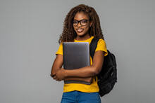 Friendly African Woman High School Student Typing On Portable Computer Isolated On Gray Background