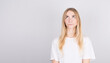 © Studio Nova - Photo of amazing blonde girl looking up empty space deep thinking isolated on grey background with copyspace.