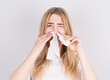 © Studio Nova - Sick woman instills drops in her nose napkin on a white background, Medicine and season flu concept.
