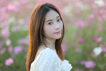 Beautiful young woman with white dress on garden background