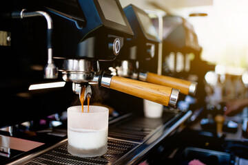 Coffee extraction with a coffee machine in a cup at a coffee shop