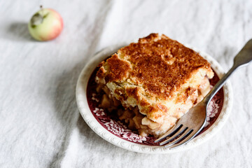 Wall Mural - Apple and Cheese Cobbler Crisp. Cobbler or Crumble dessert with apples on plate on beige linen table. Selective focus