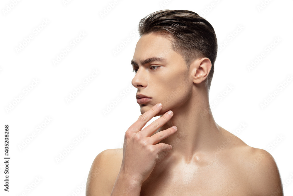 Thoughtful. Portrait of young man isolated on white studio background. Caucasian attractive male model. Concept of fashion and beauty, self-care, body and skin care. Handsome boy with well-kept skin. - obrazy, fototapety, plakaty 