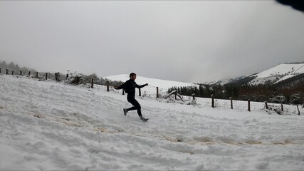 young man running in a snowed mountain