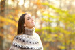 © Antonioguillem - Relaxed woman breathing fresh air in a park in winter