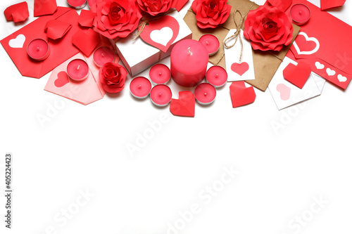 Several pink wax candles, gifts, love letters, 3D handmade red paper roses and hearts on white background. Love, Valentine's, mother's, women's day, relations, romantic, wedding concept 