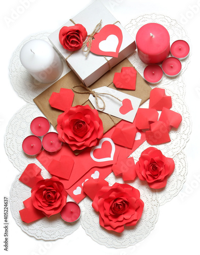 Love, Valentine's, women's day, relations, romantic composition from gifts, love letter, pink and white candles, 3D paper handmade roses and hearts on openwork paper napkins on white background 