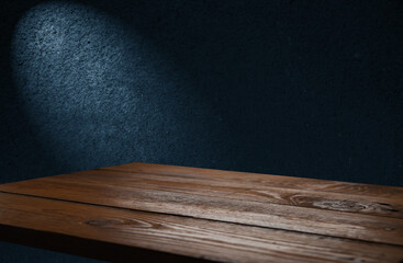 image of a wooden table on an abstract dark background with light in the center