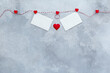 Valentines day, wedding invitation background, red hearts and two Valentine's Day cards hanging on a rope . top view, flatly, copy space.
