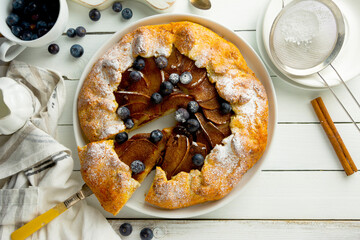 Wall Mural - Galette or pie, tart with pears and cinnamon filling. Top view, white wooden background.