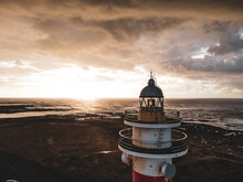 Lighthouse Close Up At Sunset Aerial Drone Shot. Cloudy Dark Sky. El Cotillo, Fuerteventura Island