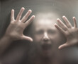 © Melinda Nagy - Scary picture of hands behind glass.
