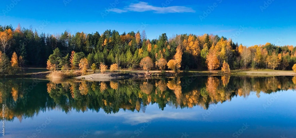Reflection Of Trees In Lake Against Sky - obrazy, fototapety, plakaty 
