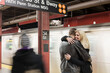 © LOUIS CHRISTIAN/Westend61 - Girlfriend smiling while embracing boyfriend standing at subway station