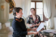 © Emma Innocenti/Westend61 - Happy female client looking at design standing by interior designer at home