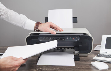 Wall Mural - Man copying and scanning documents in office.