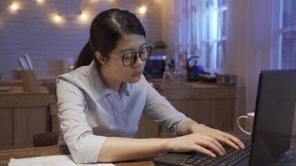 Wall Mural - Sleepy exhausted woman worker working in home kitchen with laptop computer feeling tired. lady eyes are closing about to fall asleep while typing keyboard. sleep deprivation overtime working concept