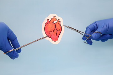 Heart surgery. Medical instruments and drawing of heart on blue background.